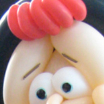 Close up of eyes and an odd red tuft of hair.